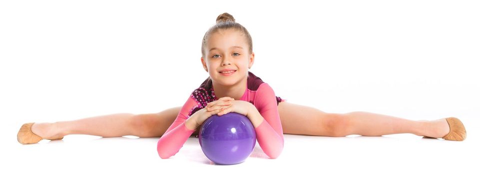 Little gymnast with ball on a white background. Sporting exercise, stretch, flexibility, aerobics
