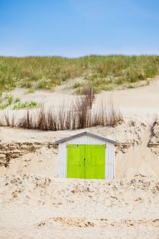 Colorfull Dutch house on the beach with blue sky. Texel, Holland