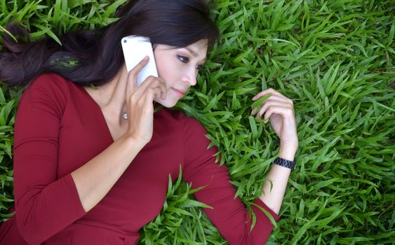 pretty woman making a phone call in the garden