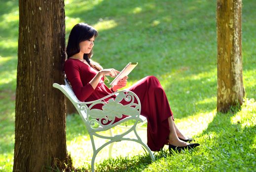 pretty  woman using  tablet in the garden