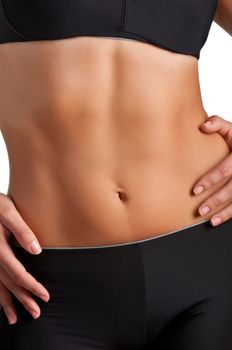 Closeup of a fit woman's abs isolated on a white background