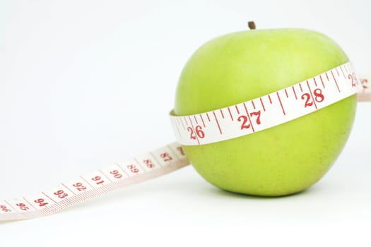 Fresh apple with measuring tape