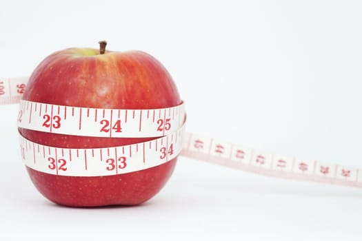 Fresh apple with measuring tape