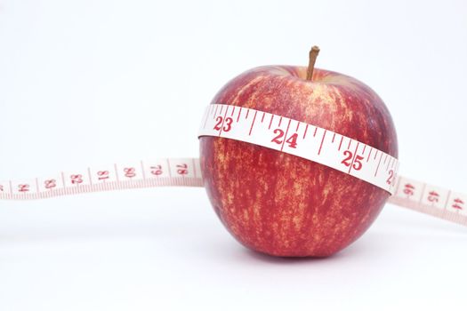 Fresh apple with measuring tape