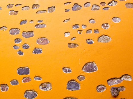 Orange adobe wall in San Miguel de Allende Mexico