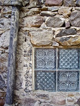 Window and drainpipe on old Mexican building