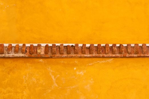 Yellow adobe wall with brick trim Guanajuato Mexico