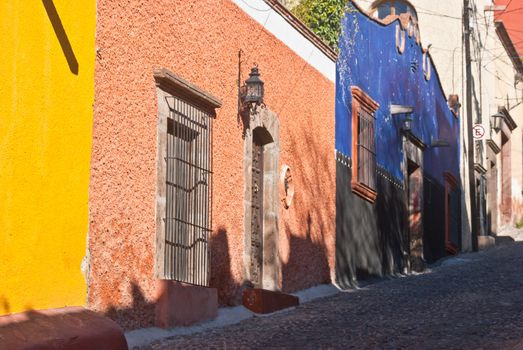 Colorful Mexican houses on a steep cobblestone street in San Miguel de Allende