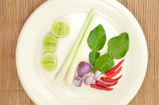 Closeup of Thai ingredients, lime, lemongrass, chili, shallots and lime leaves