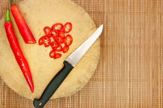 Knife and red chilli on cutting board , cooking concept