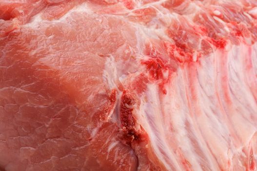 Background of Perfect Raw Pork Chop with Ribs closeup