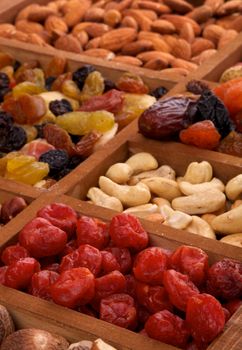 Background Dried Cherries, Cashew and Various Nuts in Wooden Box closeup 