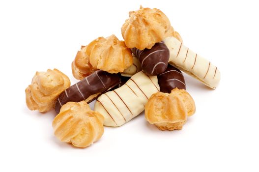 Heap of Profiterole and Eclair with Dark and White Chocolate Glaze closeup on white background