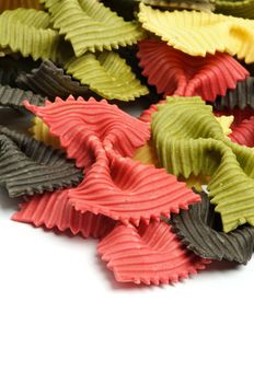 Raw Pasta Three Color Farfalle closeup on white background