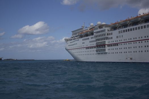 A very large cruise ship in a tropical location.