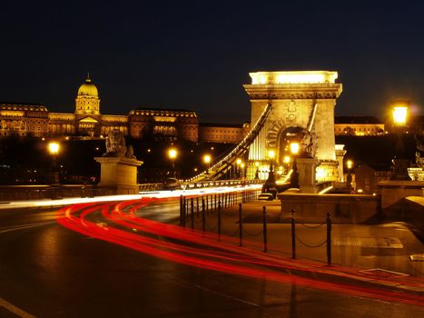 Budapest Chain Bridge at night with cars.