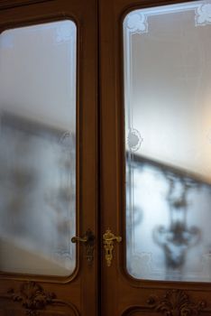 staircase of nineteenth century palace seen through glass doors