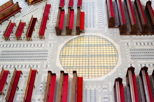 Beautiful church interior with red prayer benches seen from above