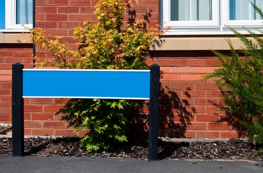 empty blue real estate sign and house (copy-space available for your design)