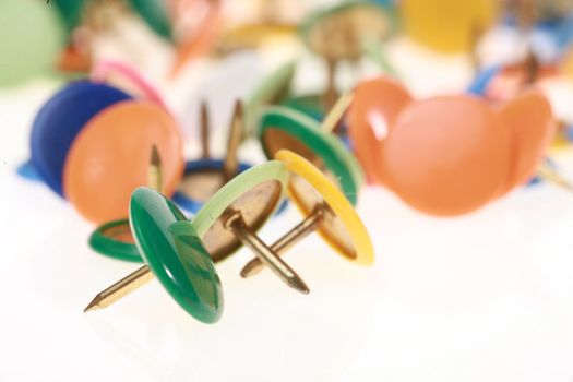 close-up of thumb tacks on a white backgroun