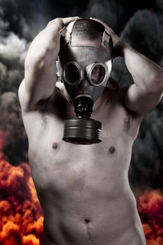 Nude man with gas mask over explosion background