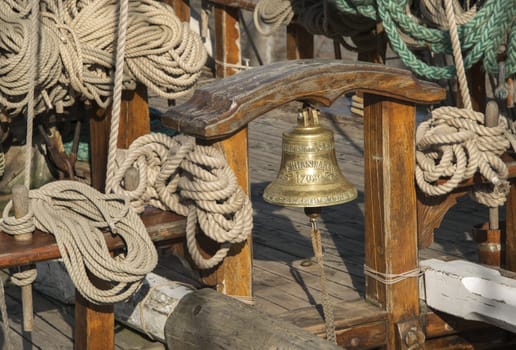 original old ship bell and ropes on the ship