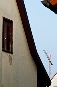 building crane with old house