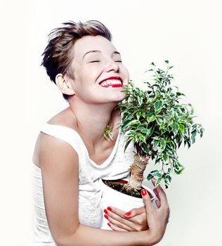 laughing girl with a plant in hand