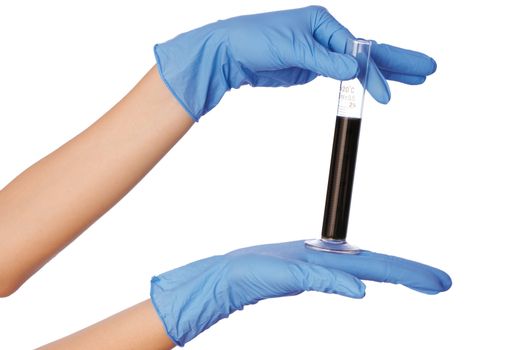 Woman in blue gloves holding sample of fractions of oil typed in a tube for experiments in the hand