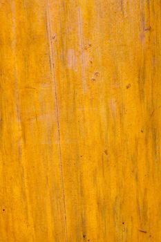 A background of wood grain creates a texture image in brown yellow. This is pine or fir in a vertical orientation.