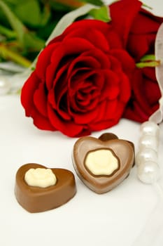 Rose, pearls and chocolate. Traditional beauty valentine composition