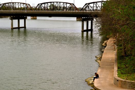 Waco woman reads on bank of river