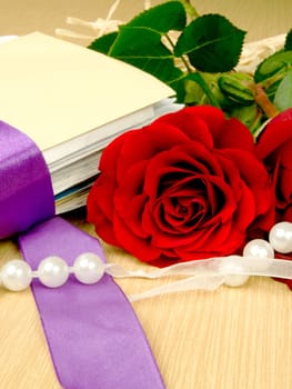 Rose, mail and pearls. Traditional beauty composition on wooden