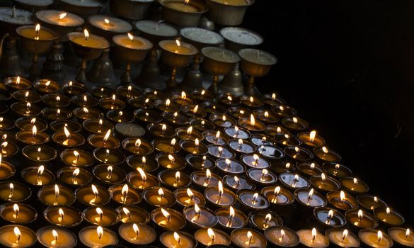 many candles in a row, dark background