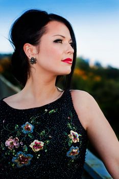 Beautiful brunette in the park  looking at the camera