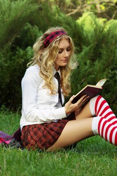 Student girl reading books in the park