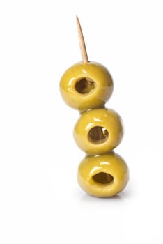 Three olives on a toothpick isolated on a white background