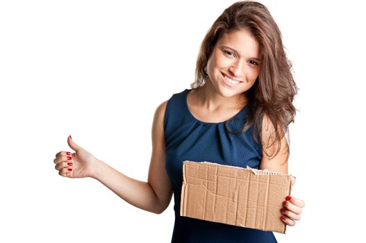 Young woman hitch hiking, holding a cardboard, isolated on a white background