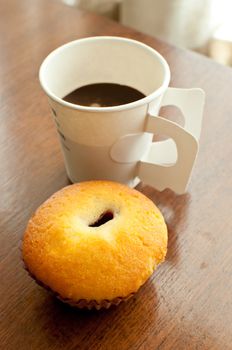 A paper cup of coffee and bakery serve on break