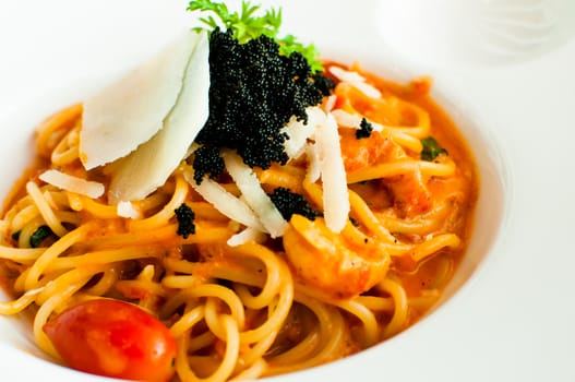 Spaghetti with tomato and chilli sauce ,decorated with black tobiko