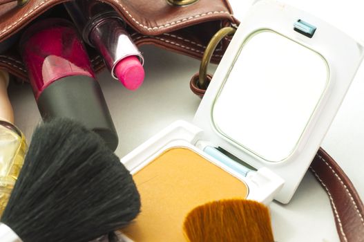 woman leather bag with cosmetics , tools and brushes