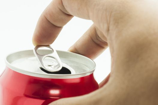 hand opening red aluminum can, isolated on white background