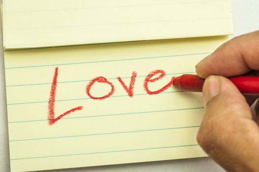 Hand writing love note with crayon