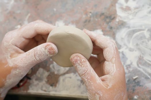 children learning to make pottery out side