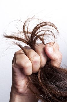 Woman hand grabbed damaged hair