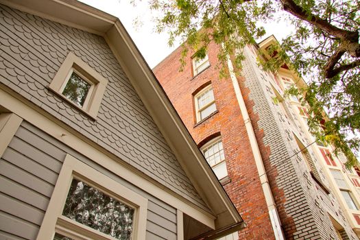 Two homes differ dramatically in a downtown area of portland oregon.