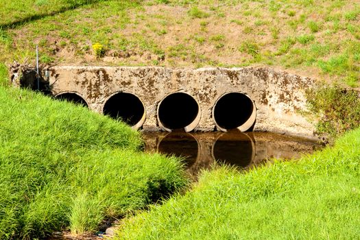 Four tunnels create a passageway for water under a road.