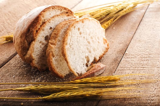 sliced bread and wheat on the wooden table