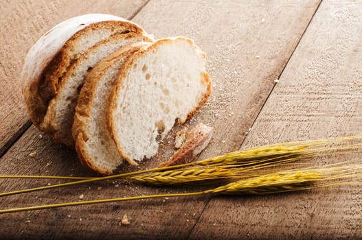 sliced bread and wheat on the wooden table