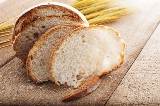 sliced bread and wheat on the wooden table